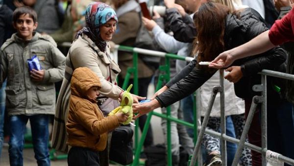 A refugee family receives presents as they arrived at the train station in Munich, southern Germany. (AFP/File)