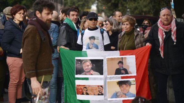 Protesters hold an Italian flag covered with photos of murdered Italian student Giulio Regeni. (AFP/File) 
