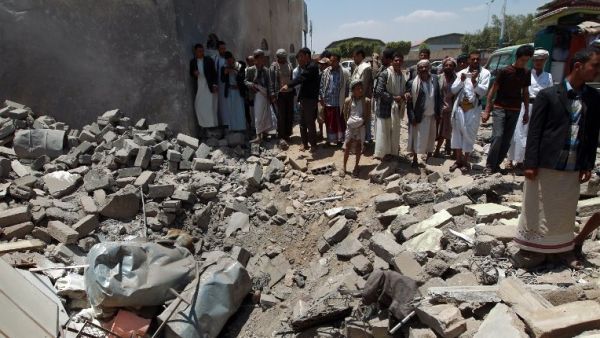 Yemenis gather near the rubble of houses close to Sanaa Airport, March 31, 2015, after they were destroyed in an air strike a Saudi-led coalition warplanes. (AFP/ Mohammed Huwais) 