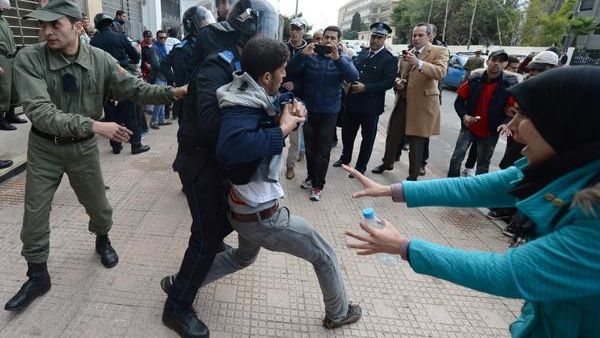 Unemployed and visually impaired Moroccan graduates scuffle with security forces as they try to enter the Ministry of Solidarity, Women, Family and Social Development in Rabat, on Thursday, to protest against unemployment. (AFP/File)