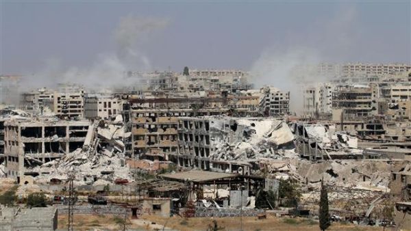 Smoke billows from buildings during battles on the northwest outskirts of Aleppo, Syria. (AFP/File)