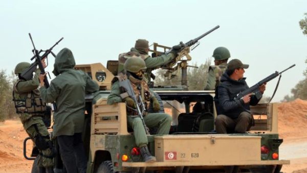 Members of the Tunisian military patrol a road near the Libyan border on March 10, 2016 in Bouhamed, 40 km from the town of Ben Guerdane. (AFP/Fathi Nasri)