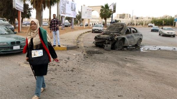 A woman walks near a damaged car after shelling hit a protest rally in Benghazi on May 6, 2016. (AFP/File) A woman walks near a damaged car after shelling hit a protest rally in Benghazi on May 6, 2016. (AFP/File)