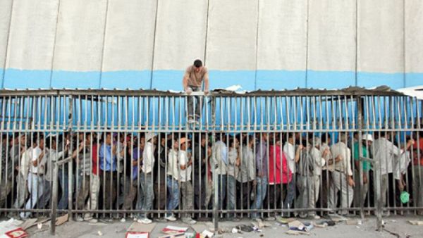 Thousands of Palestinian workers cross through checkpoints every day. (AFP/File)