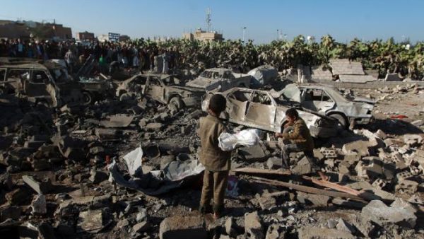 Yemenis stand at the site of a Saudi air strike against Houthi rebels near Sanaa Airport. (AFP/File)  