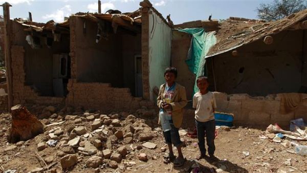 Yemeni children stand outside houses which were destroyed several months ago in an airstrike by Saudi warplanes at a slum in Sana'a, March 12, 2016. (AFP/File)
