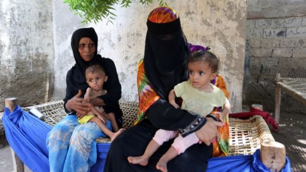 Yemeni women sit with their malnourished children on September 26, 2016 in an impoverished coastal town. (AFP/File)