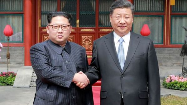 North Korean leader Kim Jong-un shakes hands with Xi Jinping in Beijing. (AFP/ File Photo)