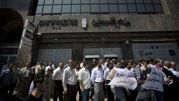 The banking crisis started last Wednesday with Hamas-affiliated police officers preventing PA employees from collecting their wages (AFP/ File).