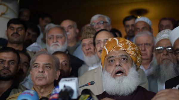 Shahbaz Sharif (R), younger brother of ousted Pakistani Prime Minister Nawaz Sharif and head of Pakistan Muslim League-Nawaz (PML-N), arrive with opposition leader Maulana Fazalur Rehman (L) for a press conference after attending an All Parties Conference in Islamabad on July 27, 2018. (AFP/Aamir Qureshi)
