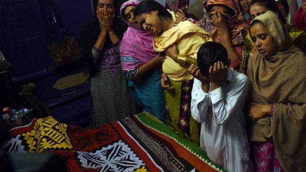 Pakistani relatives mourn over the coffin of a 13-year-old blast victim Zeeshan during his funeral on February 17, 2017, after a bomb blew up in the shrine of 13th century Muslim Sufi saint Lal Shahbaz Qalandar. (AFP/Asif Hassan)
