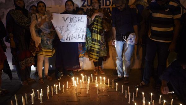 Pakistani activists and mourners light candles during a vigil in Karachi on February 17, 2017, to pay tribute to the victims of a bomb attack on a Sufi Muslim shrine. (AFP/Rizwan Tabassum)