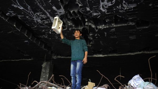 A Palestinian boy plays in the ruins of a building that was destroyed in the 2014 war between Israel and Hamas militants, in Gaza City, on February 16, 2016. (AFP/Mohamed Abed) A Palestinian boy plays in the ruins of a building that was destroyed in the 2014 war between Israel and Hamas militants, in Gaza City, on February 16, 2016. (AFP/Mohamed Abed)