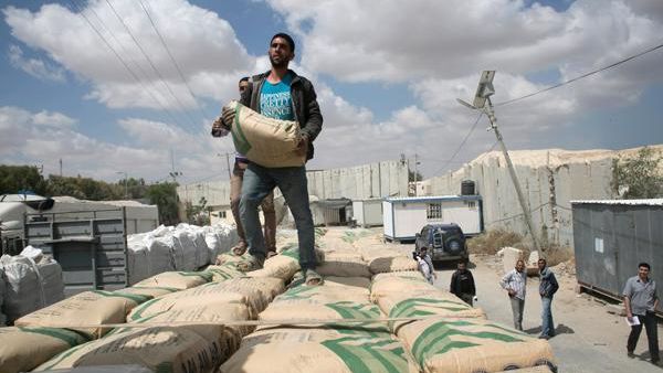 Israel restricts the entry of goods into Gaza out of fears they will be used to build tunnels, but Gazans desperately need cement for reconstruction. (AFP/Said Khatib)