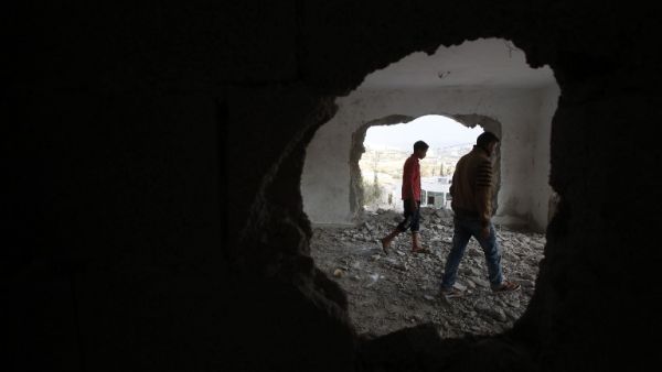 A relative and the brother (R) of late Mohammed Nasser Tarayrah, a Palestinian attacker who stabbed to death an Israeli teen in a Jewish settlement, inspect Tarayrah's home after Israeli army partially destroyed it on August 15, 2016 in the village of Bani Naim, near the Palestinian city of Hebron. (AFP/Hazem Bader)