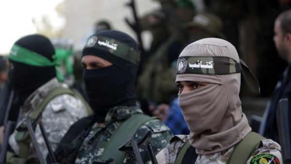 Palestinian members of the Qassam Brigades, the armed wing of Hamas mourn during the funeral of Ahmed al-Zahar in the village of Al-Moghraga in the Gaza Strip on February 3, 2016. (AFP/Mahmud Hams)