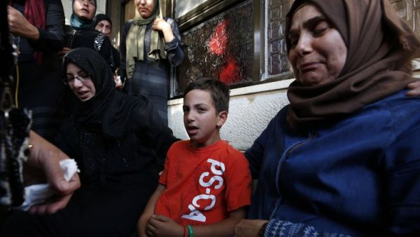 Relatives of Iyad Hamed, 38, mourn during his funeral in the West Bank village of Silwad after he was killed by Israeli troops on August 26, 2016. (AFP/Abbas Momani)