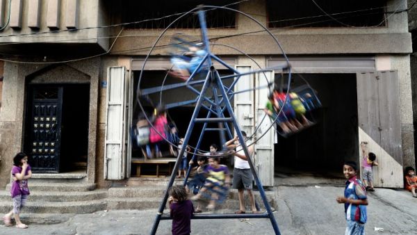 Palestinian children play on a street in the center of Gaza City on June 29, 2016. (AFP/Thomas Coex)