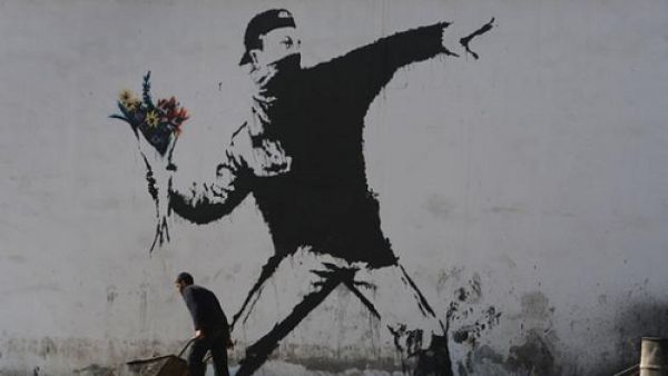 Banksy graffiti in the West Bank town of Bethlehem shows nonviolent Palestinian resistance (Flickr)