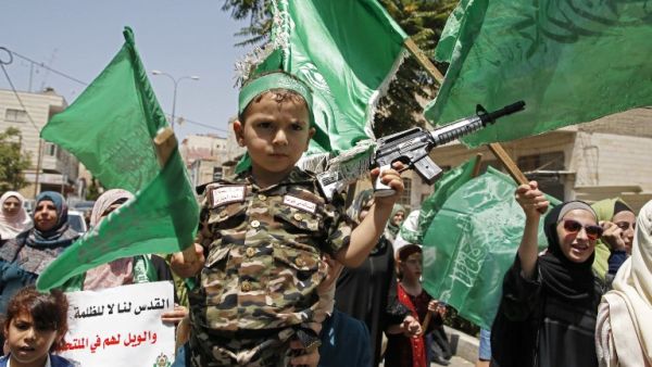 Palestinian Hamas movement supporters march in the city of Hebron in the Israeli-occupied West Bank, on July 28, 2017 (Hazem Bader/AFP)