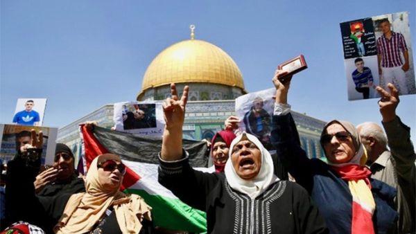 Families of Palestinians imprisoned in Israeli jails demonstrate outside Dome of the Rock at Al-Aqsa mosque compound in Jerusalem's Old City (AFP)