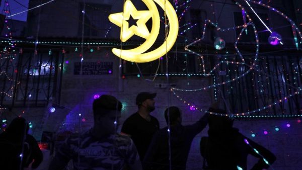 Palestinian men stand amidst Ramadan lights at a shop in the old city of Jerusalem as the faithful prepare for the start of the Muslim holy fasting month of Ramadan on May 26, 2017. (Ahmad Gharabali/AFP)