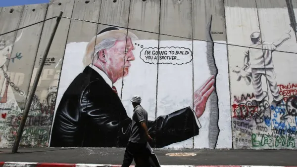 'I'm going to build you a brother' reads new West Bank separation wall graffito (AFP)