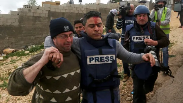 A Palestinian TV correspondent is transported away from clashes following a weekly demonstration against the expropriation of Palestinian land by Israel in the village of Kfar Qaddum, near Nablus, in the occupied West Bank on March 3, 2017. (AFP/Jaafar Ashtiyeh)