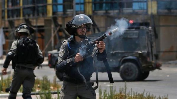 An Israeli border guard fires a teargas canister towards Palestinian protesters during clashes near the settlement of Beit El, near the occupied West Bank city of Ramallah. (AFP/File)