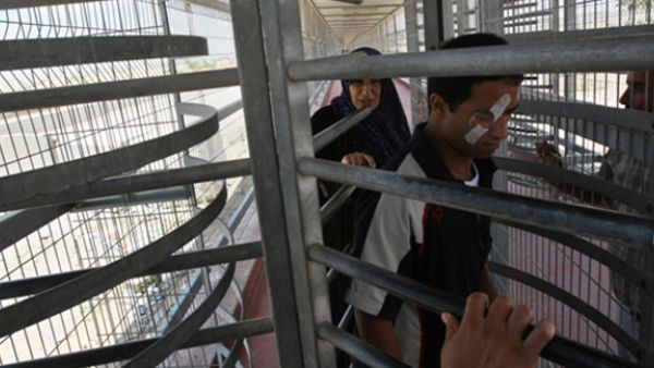 Palestinians walk through the Erez border crossing with Israel in the northern Gaza Strip as they cross into Gaza, on June 09, 2010. (AFP/Mahmud Hams)