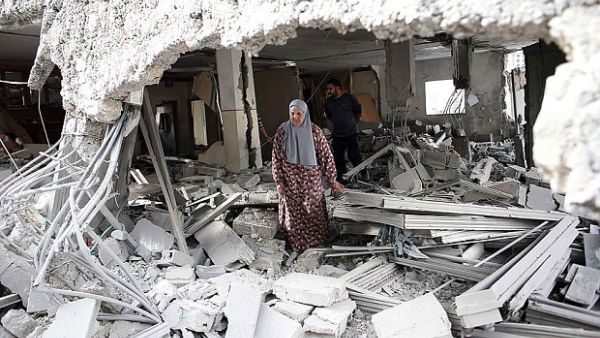 A file photo of a Palestinian woman standing inside her demolished home. (AFP/File)