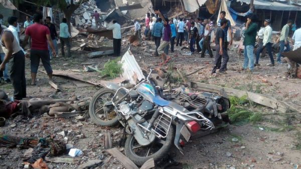 People gather around the site of an explosion at a restaurant in the central Indian state of Madhya Pradesh on September 12, 2015, where 88 people were killed and 100 injured (AFP)