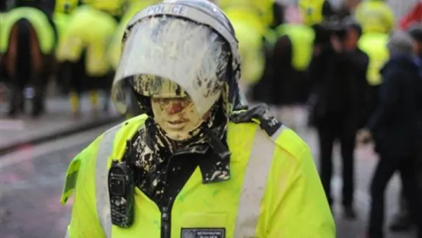 A British riot policeman is covered in paint during student demonstrations in London, on December 9, 2010. Angry demonstrators clashed with police in a student protest outside parliament Thursday as the coalition government faced its biggest test yet in a vote on proposals to triple university tuition fees