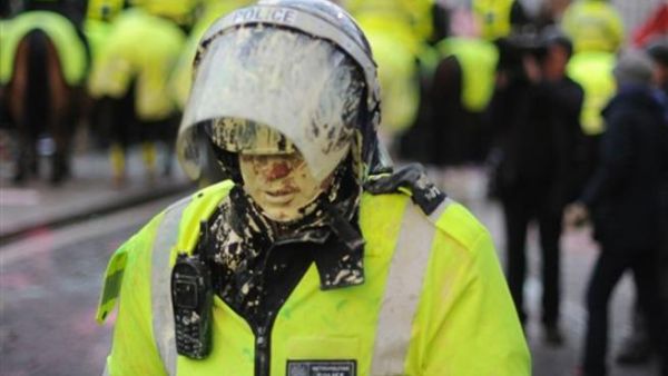 A British riot policeman is covered in paint during student demonstrations in London, on December 9, 2010. Angry demonstrators clashed with police in a student protest outside parliament Thursday as the coalition government faced its biggest test yet in a vote on proposals to triple university tuition fees