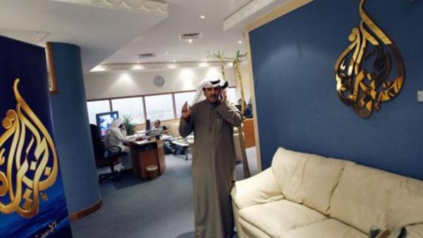 Al-Jazeera's bureau chief in Kuwait Saad al-Saedi talks on his mobile phone at the channel's office in Kuwait City on December 13, 2010