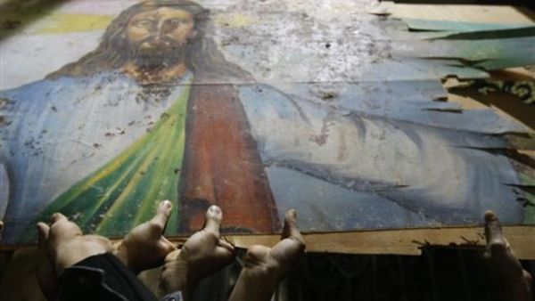 Egyptian Christians hold a blood-stained portrait of Jesus Christ during a protest late on January 2, 2011 outside the Al-Qiddissine (The Saints) church in Alexandria, following a New Year's Eve car bomb attack on the Coptic church in the northern Egyptian city in which 21 people were killed.