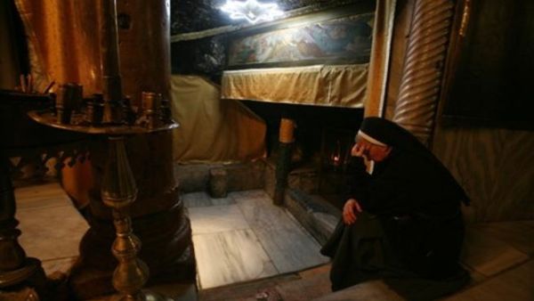 A nun prays at the Church of the Nativity, believed to be the birthplace of Jesus Christ, in the West Bank town of Bethlehem on December 24, 2010 as the Holy Land prepares to mark Christmas
