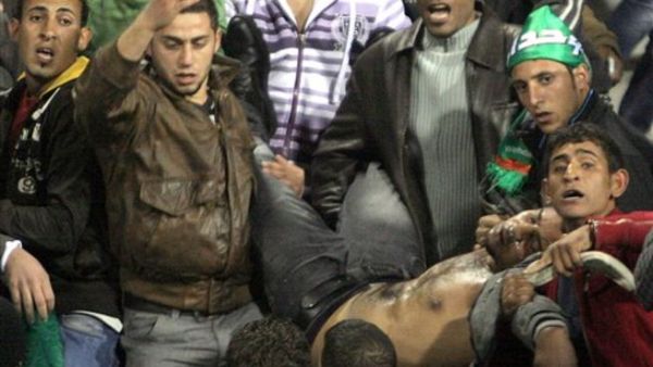 Jordanians carry a football fan injured during clashes following the Jordanian professional league football match between Al-Wihdat and Al-Faisali in east Amman on December 10, 2010