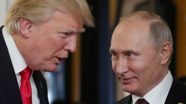 US President Donald Trump chats with Russia's President Vladimir Putin as they attend the APEC Economic Leaders' Meeting (Mikhail Klimentyev/AFP)