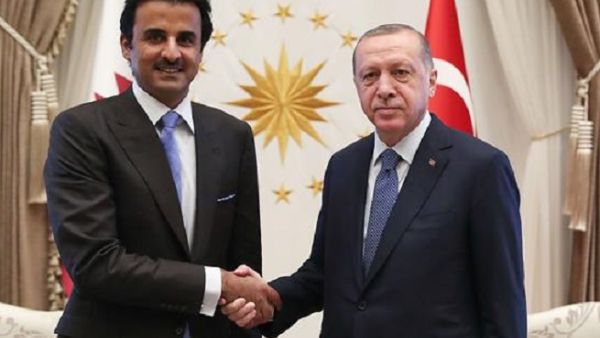 This handout photo taken and released by the Turkish presidential press service on August 15, 2018 shows Turkey's President Recep Tayyip Erdogan (R) and the Emir of Qatar Sheikh Tamim bin Hamad Al-Thani shaking hands prior to their talks in Ankara. (AFP)