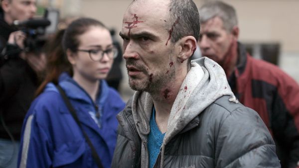 An injured man leaves the scene of an explosion in St Petersburg.  (AFP)