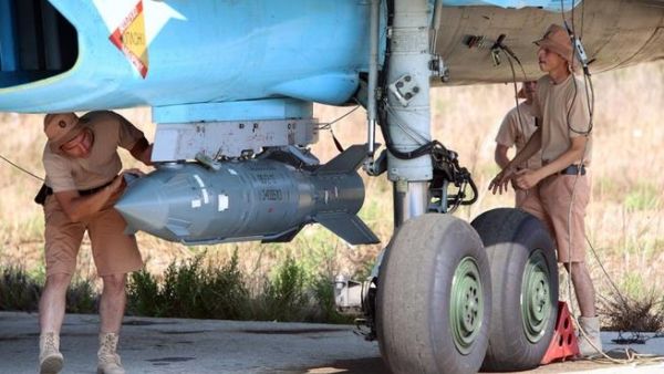 Russian technicians check a bomber at an airbase in Syria. (AFP/Alexander Kots) Russian technicians check a bomber at an airbase in Syria. (AFP/Alexander Kots)