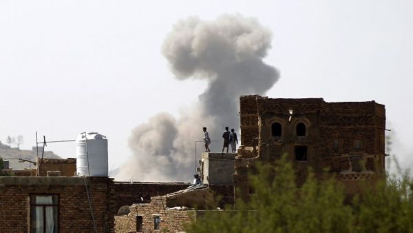 Yemenis stand on a rooftop after an airstrike carried out by the Saudi-led coalition in the Yemeni capital Sanaa on September 25, 2016. (AFP/Mohammed Huwais)