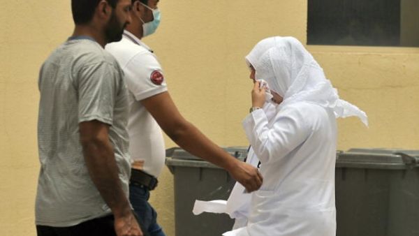 Saudi nurses and citizens walk outside the King Fahad hospital in the city of Hofuf, some 370 kilometres East of the capital Riyadh, on June 16, 2013. (FAYEZ NURELDINE/AFP/Getty Images)