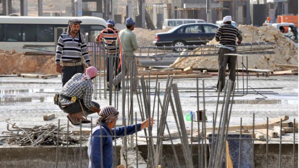 Foreign laborers work at a construction site in the Saudi capital Riyadh. Like women, workers are deprived of the most basic rights in Saudi Arabia.  (Image credit: AFP)