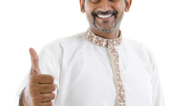 Excited thumb up Indian man in traditional costume kurta dhoti (Shutterstock/szefei)