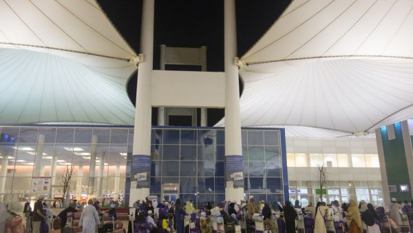 Pilgrims line up outside the Jeddah airport in Saudi Arabia. (Shutterstock)