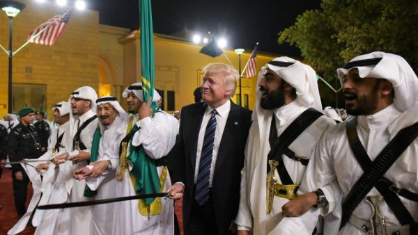 US President Donald Trump joins dancers with swords at a welcome ceremony ahead of a banquet at the Murabba Palace in Riyadh on May 20, 2017. (AFP/Mandel Ngan)