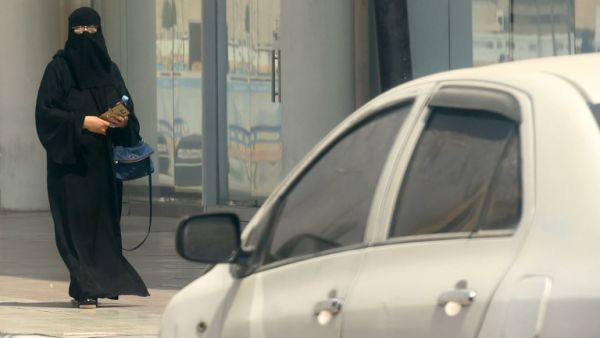 A Saudi woman walks near car down a street in the Saudi capital Riyadh on September 27, 2017 (FAYEZ Nureldine/AFP)