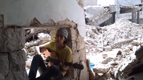 A young Syrian sings in the midst on being targeted by bombs. (YouTube image grab)